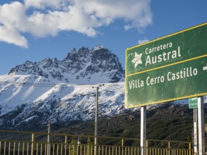Signpost on road Carretera Austral at Villa Cerro Castillo, snowcapped Mt .Cerro Castillo,