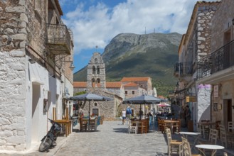 Lively square with church in the background and an impressive mountain backdrop, double church