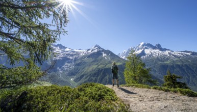 Mountaineer on hiking trail, mountain panorama with glaciated mountain peaks, Aiguille Verte, hike