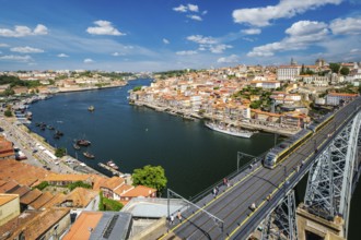 View of Porto city and Douro river with moored sailing ship and Dom Luis bridge I from famous