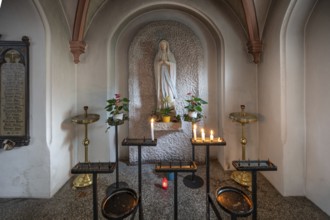 Marian altar with sacrificial candles in the neo-Gothic Basilica of Our Lady, built between 1892