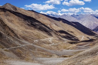 Himalayan valley landscape with road near Kunzum La pass, allegedly the highest motorable pass in