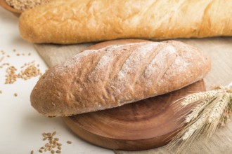 Different kinds of fresh baked bread on a white wooden background. side view, close up, selective
