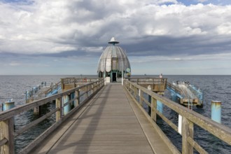 Pier with round pavilion under a cloudy sky by the sea, Rügen