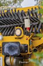 Close-up of details of a yellow machine with technical equipment, tamping machine, Hermann