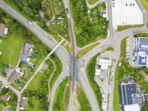 Aerial view of a road crossing with railway bridge in urban surroundings, track construction, rail