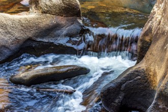 Small river and waterfall with water flowing between the rocks, Minas Gerais, Brazil, South America