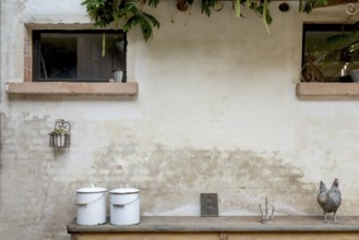 Two old enamel buckets and decorative objects on an old wooden bench, Alsace, France, Europe