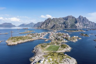 Aerial view over fishing village Henningsvaer, football stadium on rocky island, Lofoten, Norway,