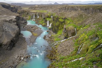Waterfalls and a turquoise blue river flowing through a canyon, Sigöldugljúfur, long exposure,