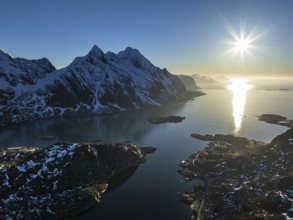 Aerial view of fjord and steep mountains, coast, winter, evening light, sun rays, Vestvagoya,