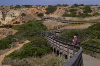 Woman on boardwalk, coastal hiking trail, wooden boardwalk, boardwalk, Ponta da Piedade, Lagos,