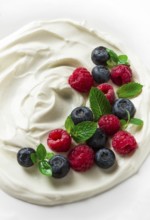Breakfast, yogurt with fresh berries, raspberries and blueberries, on a white background, selective