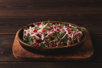 Kuchmachi, a traditional Georgian dish, in a clay Ketsi plate, close-up