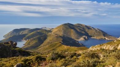 A clear picture of a bay with mountainous surroundings and blue sky on the coast, southern tip,