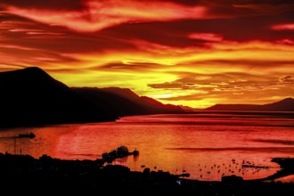 Ushuaia, Tierra del Fuego, Argentina, Glowing red sunrise over the Beagle Channel, the Beagle