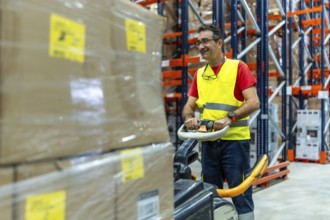 Mature happy man working in a warehouse moving boxes with forklift