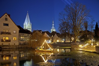 Large pond, St. Patrokli Cathedral and St. Peter's Church in the evening during winter sunshine,