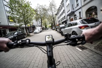 Cycling in the city, inner-city street, cycle lane, bicycles have priority, two-lane traffic with
