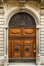 Decorated arched entrance door, historic city centre, Lucca, Tuscany, Italy, Europe