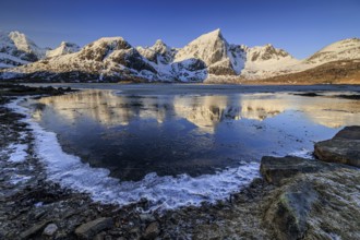Sunrise, morning light, steep mountains and fjord, ice, winter, Flakstadoya, Lofoten, Norway,