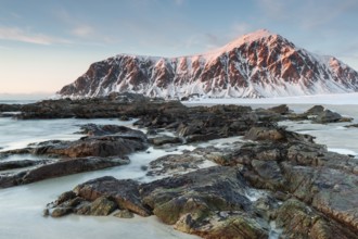 Winter evening mood at Skagsanden, rocks on the beach near Flakstad, Flakstadøy, Lofoten, Nordland,