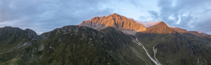 Panorama, rocky mountain peak Porze and green mountain landscape with river valley at sunrise,