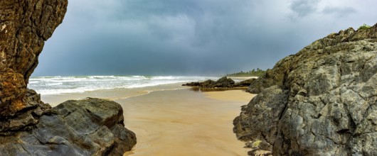Dark rain clouds over Pe de Serra beach in Serra Grande on the southern coast of Bahia