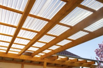 New patio roofing with wood and corrugated acrylic glass panels