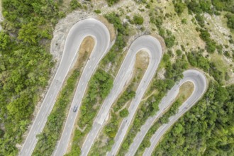 Aerial view, drone shot, Mountain pass road with multiple hairpins, water pipeline, Switzerland,