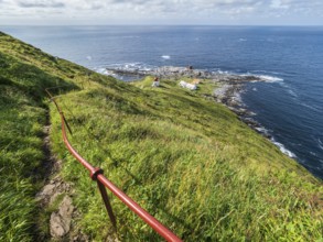 Lighthouse at the coast of island Runde, path to the lighthouse, Norway, Europe