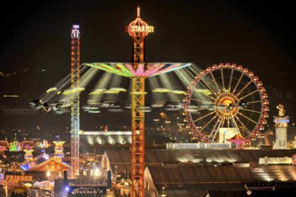 View over the Wies'n at night with illuminated carousel, Ferris wheel, stalls, beer tents and