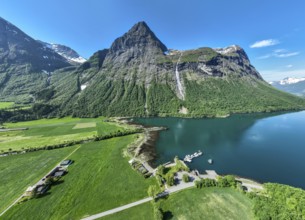 Aerial panoramic view over fjord Hjorundfjord, at village Oye, marina, waterfall, mt.