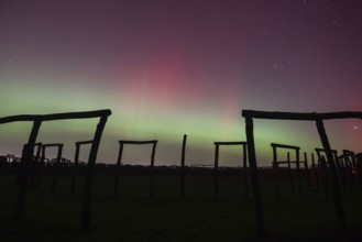 Northern lights (aurora borealis) over the ring sanctuary of Pömmelte, prehistoric circular ditch