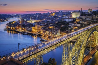 View of illuminated Porto city and Douro river and Dom Luis bridge I from famous tourist viewpoint