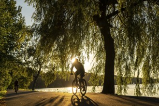 Cycling on Lake Baldeney, around 14 kilometres around the Ruhr reservoir, summer evening on the