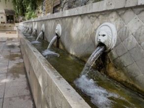 Partial view of lion fountain Venetian fountain Kefalovrisi with 25 gargoyles in the shape of