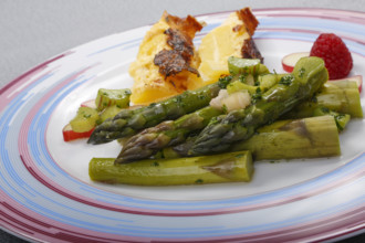 South German cuisine, green asparagus with rhubarb vinaigrette and potato gratin, healthy,