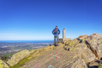 A male hiker on the top of Mount Adarra in Urnieta. Gipuzkoa, Basque Country