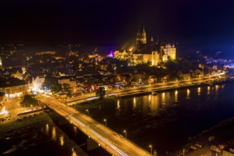 City view at night with Albrechtsburg castle, cathedral, old town, Elbe river and old Elbe bridge