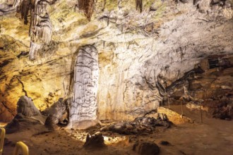 Stalagmites and stalactites creating a brilliant column inside postojna cave, a famous tourist