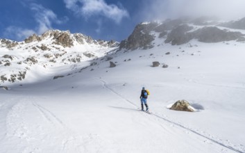 Ski tourers in a wintry mountain landscape, ascent to Porta d'Es-cha, Grisons Haute Route ski tour,