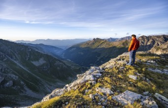 Mountaineer at the summit of Mont de la Blana, mountain landscape at sunset, view over the valley