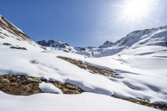 Mountain landscape with snow and sun star, ascent to Grialetsch Scharte, Bündner Haute Route,