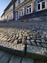 Cobblestone pavement with facades of half-timbered houses in the old town, UNESCO World Heritage
