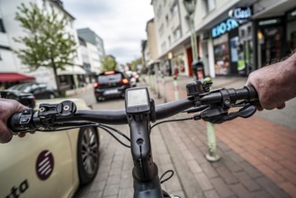 Cycling in the city, inner-city street, cycle lane, bicycles have priority, two-lane traffic with