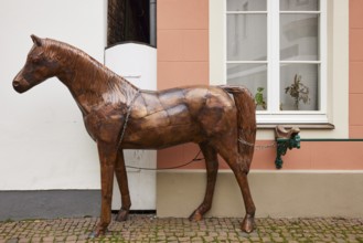 Brass horse sculpture with iron chain in the town of Warendorf, Warendorf district, North