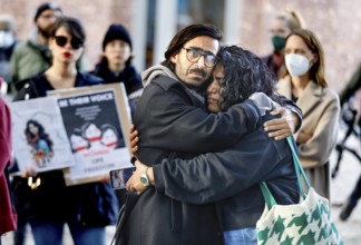 An Iranian couple embrace during a demonstration by Iranians in solidarity with the people of Iran