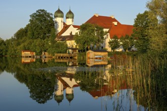 Romanesque Benedictine Abbey Seeon Monastery, monastery church St. Lambert with reflection in the