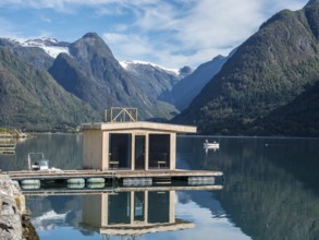 Floating sauna, village Fjaerland at the Sognefjord, glacier Jostedalsbre in the back, Norway,